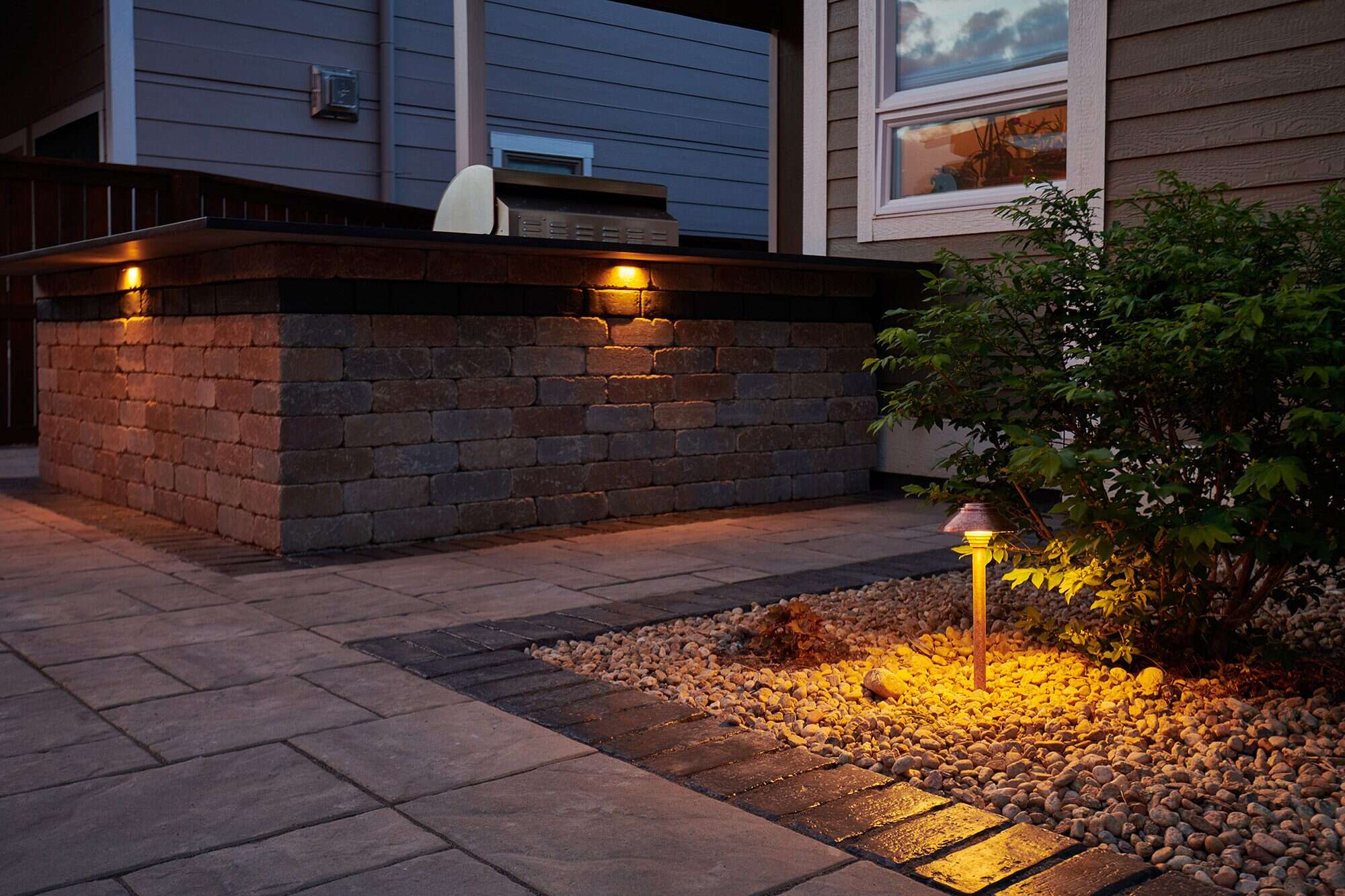 Outdoor path lighting installation at night in Lafayette, CO by Nature's Way Landscapes