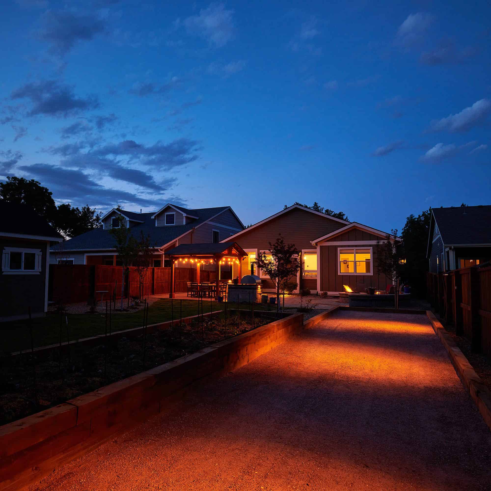 Driveway and path lighting installation at night in Lafayette, CO by Nature's Way Landscapes