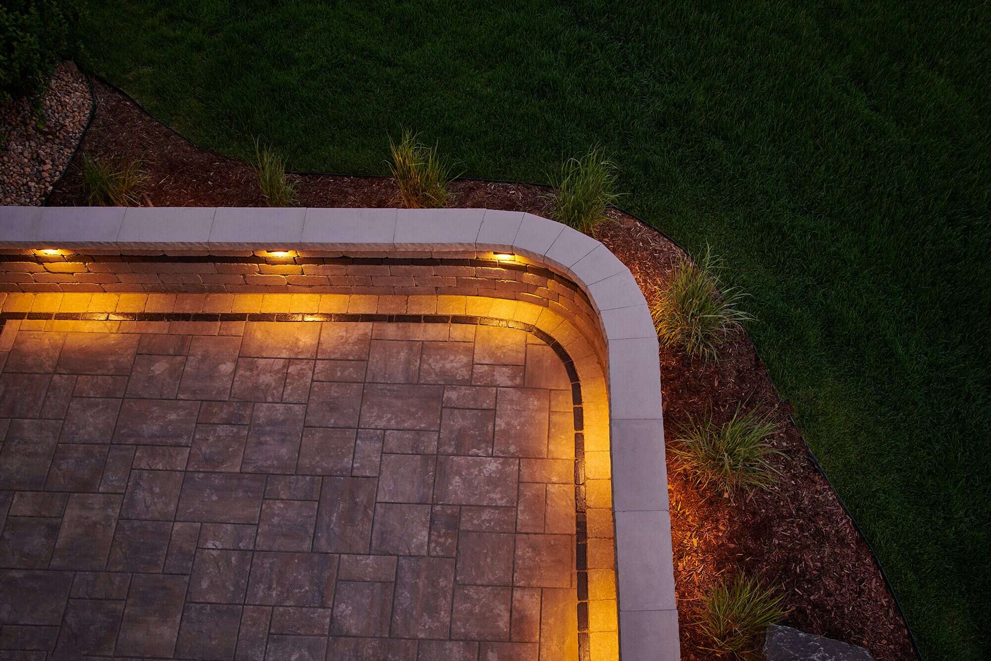 Outdoor patio lighting detail at night in Broomfield, CO by Nature's Way Landscapes