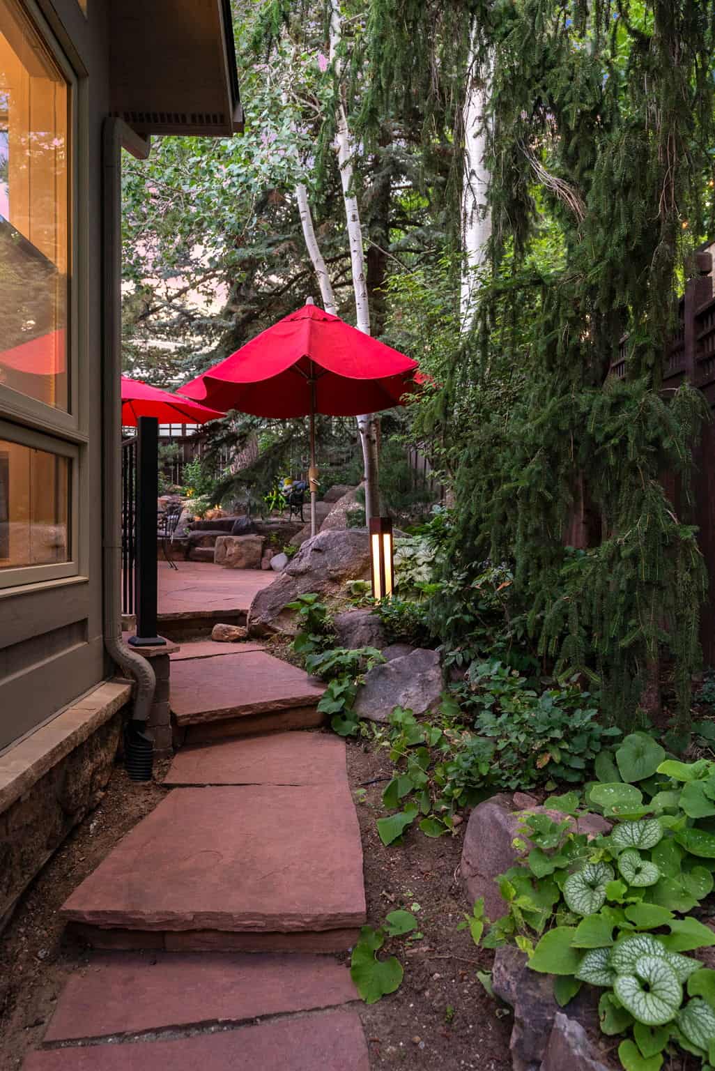 Flagstone steps with bollard landscape lighting in Boulder, CO by Nature's Way Landscapes