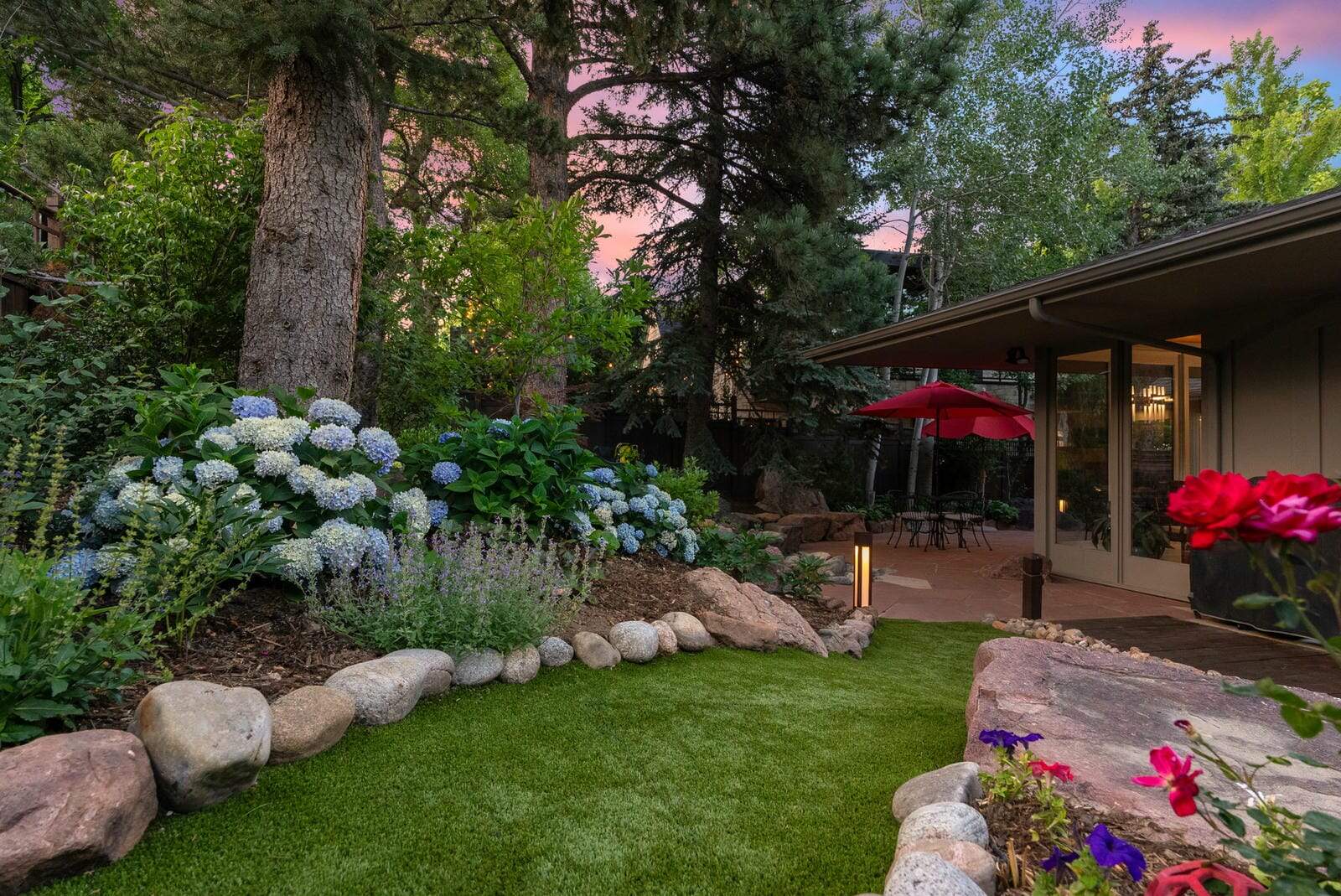 Lush garden path and planting beds in Boulder, CO by Nature's Way Landscapes