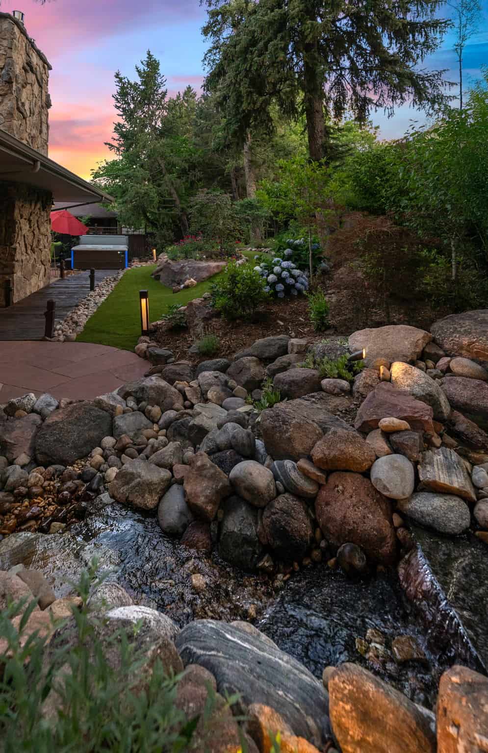 Water feature landscape enhancement at dusk in Boulder, CO by Nature's Way Landscapes