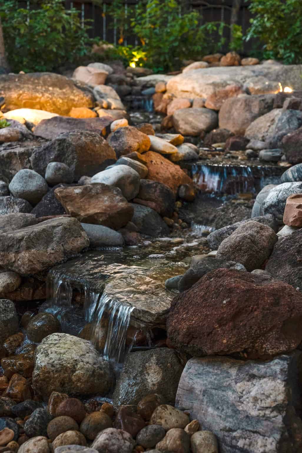 Water feature landscape enhancement at dusk in Boulder, CO by Nature's Way Landscapes
