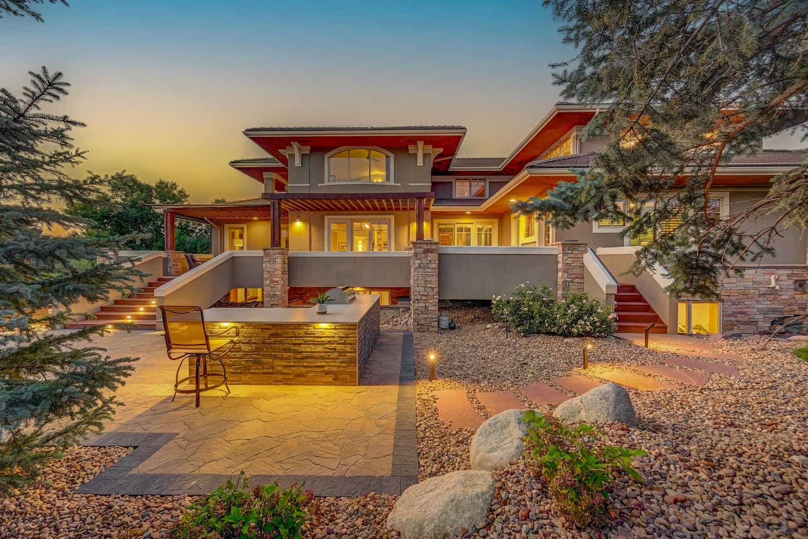 Pergola and outdoor seating area with night lighting in Boulder, CO by Nature's Way Landscapes