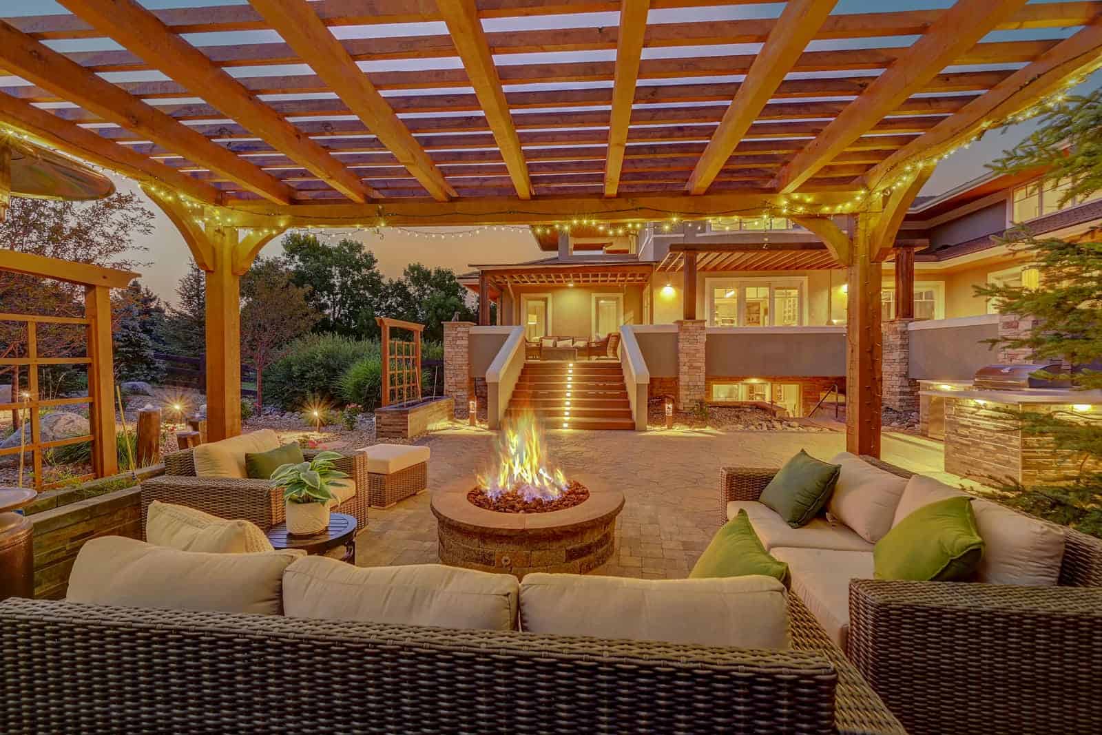 Pergola and fire pit patio installation at evening in Boulder, CO by Nature's Way Landscapes
