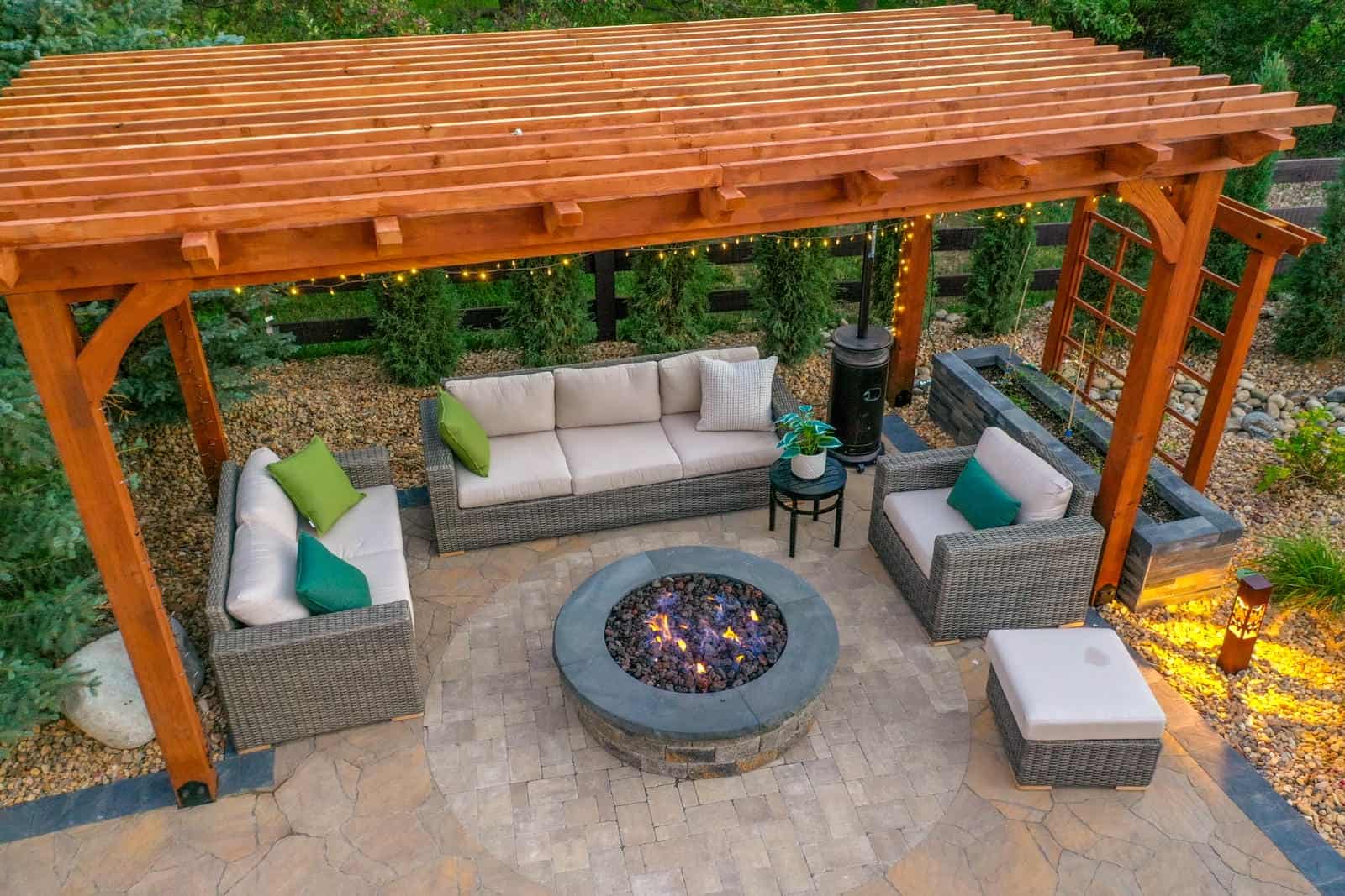 Aerial view of pergola and fire pit patio at dusk in Boulder, CO by Nature's Way Landscapes