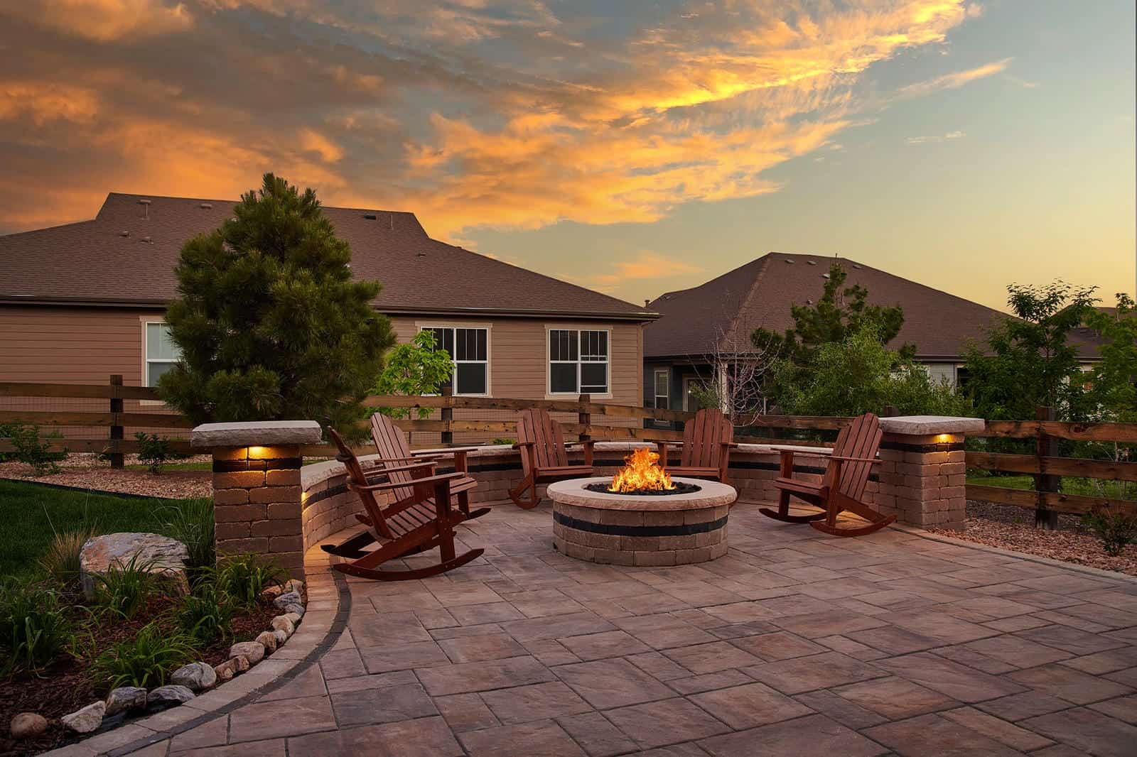 Outdoor fire pit patio with evening sky in Broomfield, Colorado by Nature's Way Landscapes
