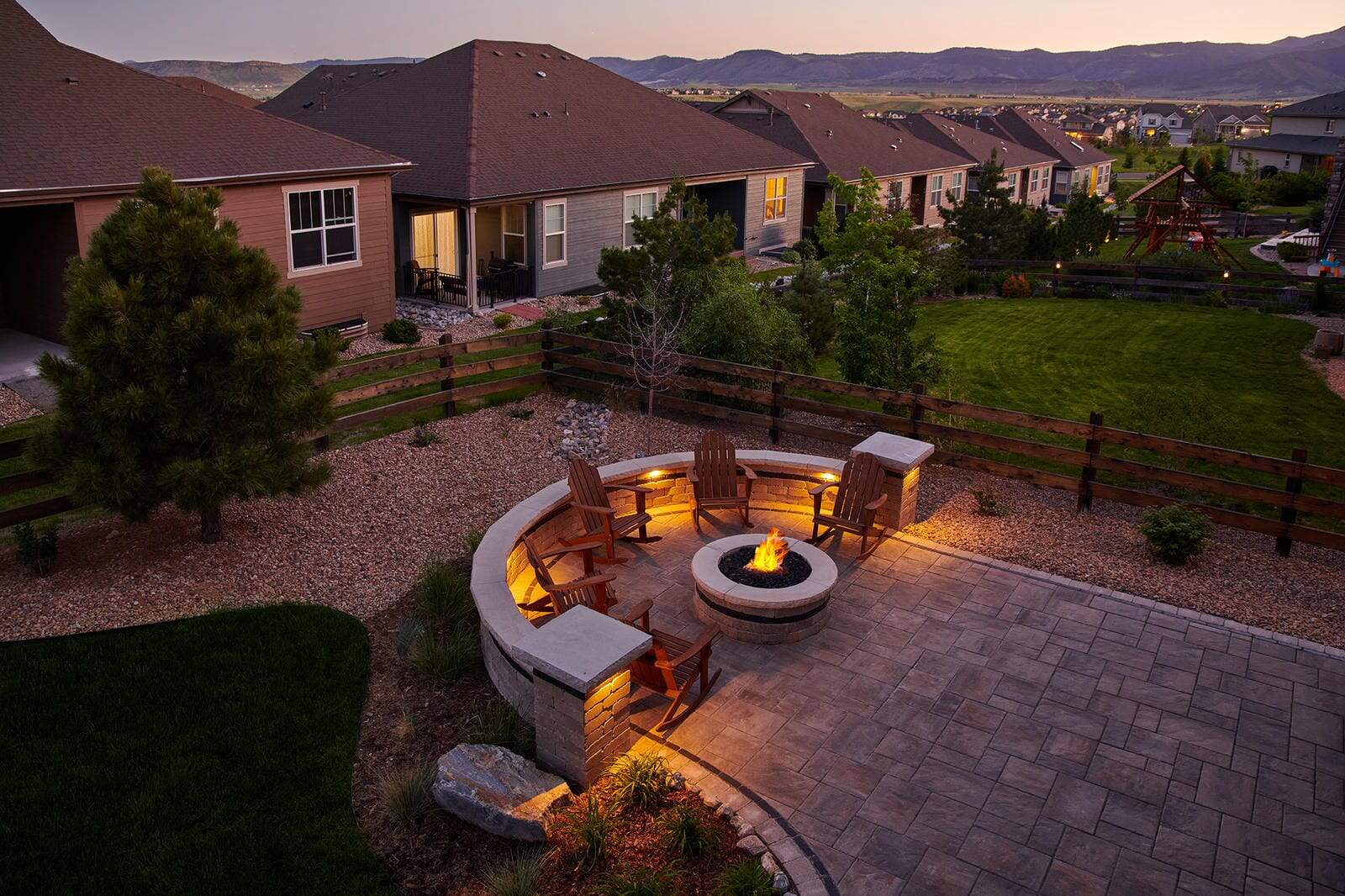 Aerial view of fire pit patio installation at dusk in Broomfield, CO by Nature's Way Landscapes