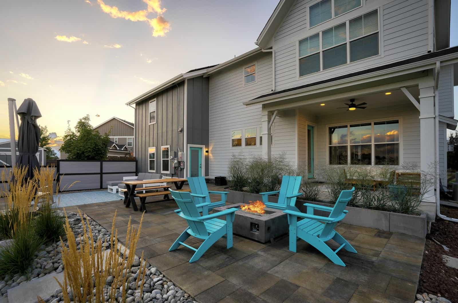 Custom patio and outdoor seating area at dusk in Erie, CO by Nature's Way Landscapes
