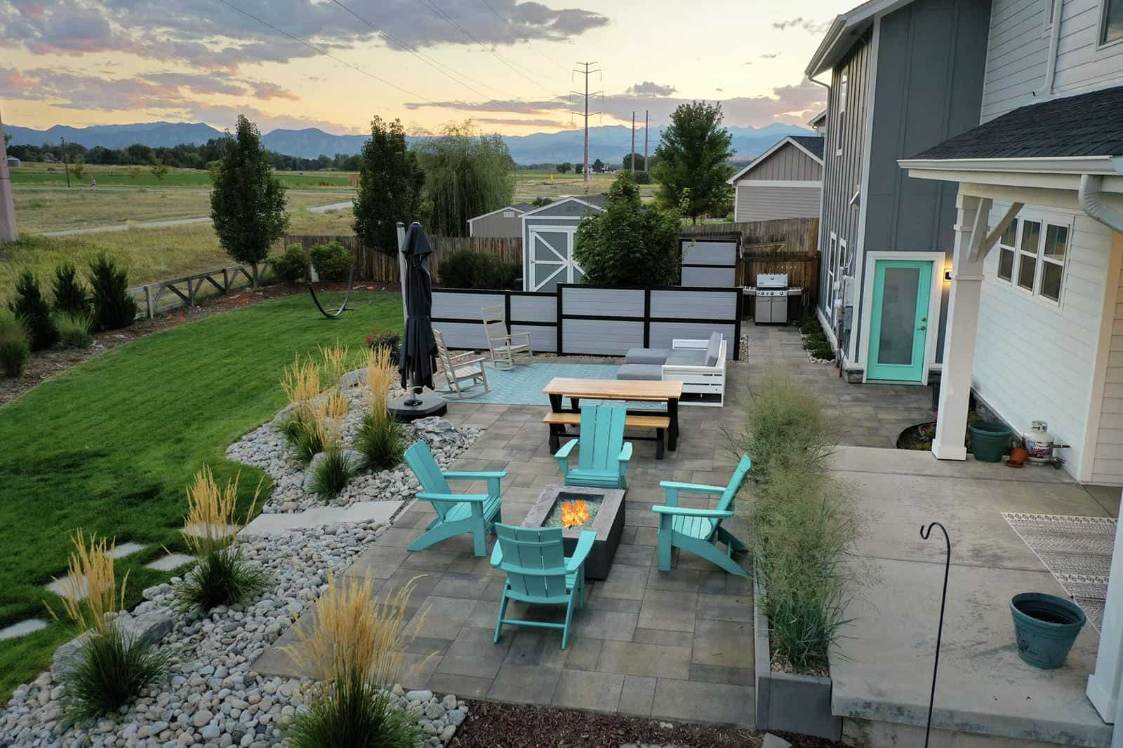 Backyard patio and landscape installation at sunset in Erie, CO by Nature's Way Landscapes