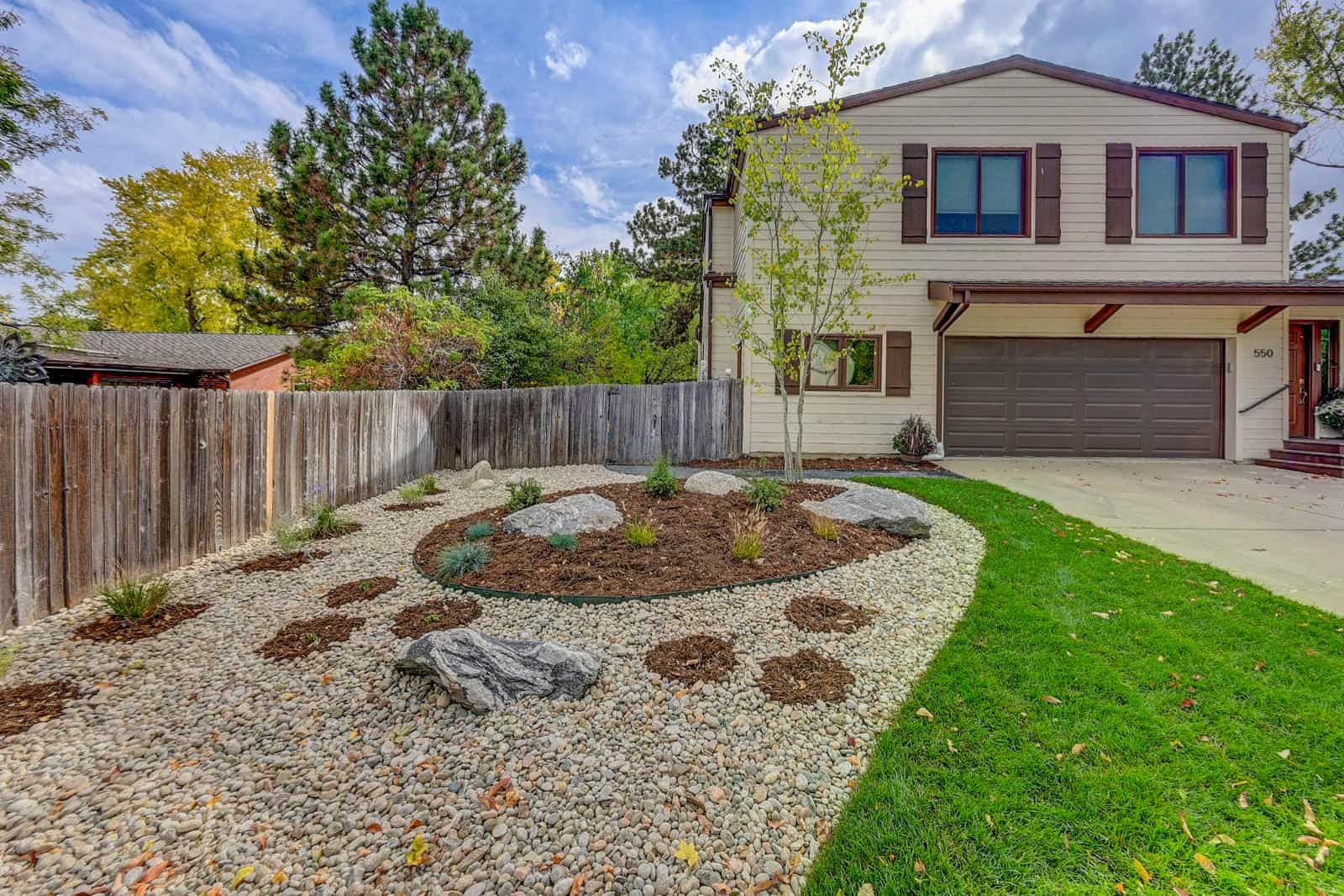Xeric front yard landscape design with boulder accents in Louisville, CO by Nature's Way Landscapes