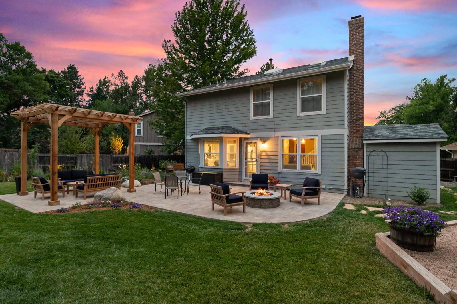 Custom pergola and backyard landscape design at sunset in Westminster, CO